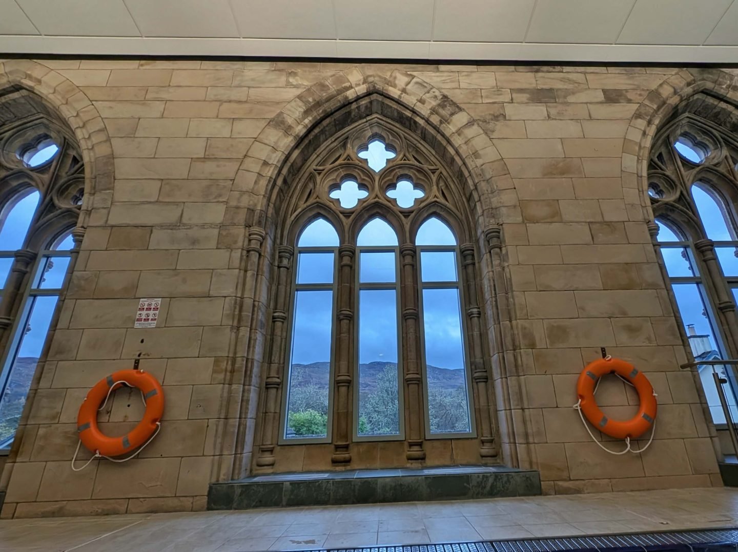 View from swimming pool out of tall, ornate windows