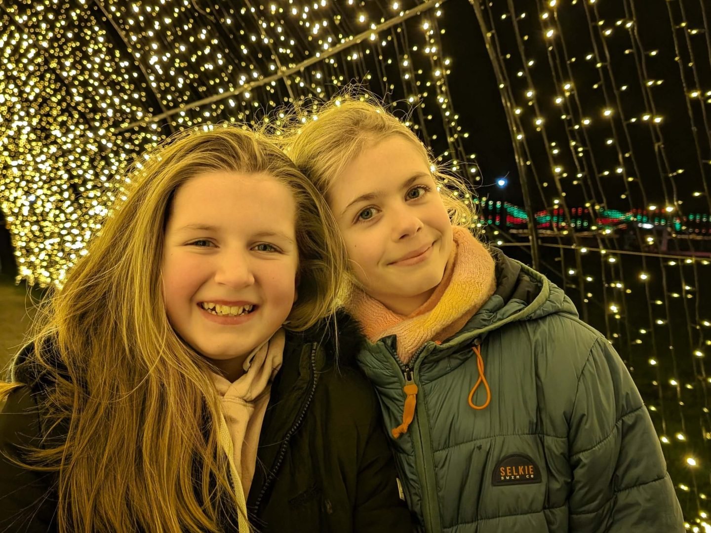 Libby and Lia under the light arch at Winter Glow