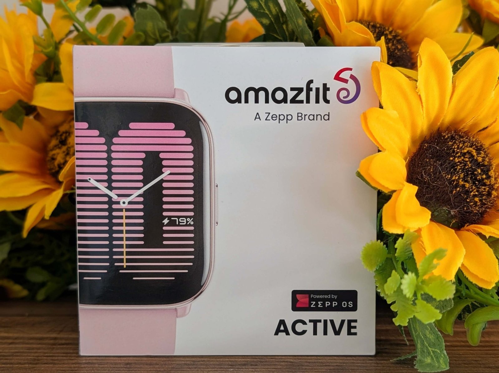 Amazfit Active in box displayed against sunflowers