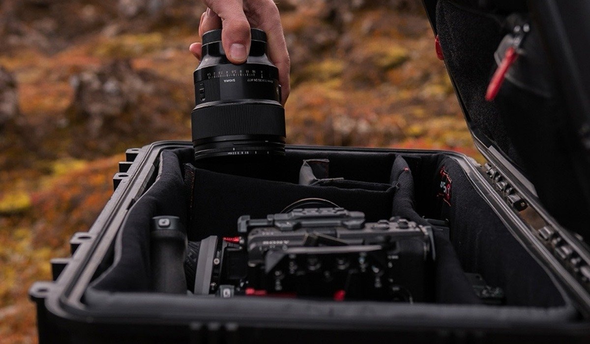 Hand placing camera lens in protective case