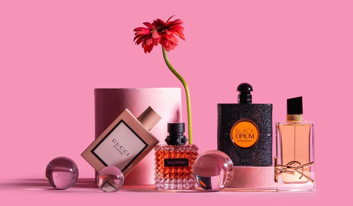 Luxury perfume bottles on pink background