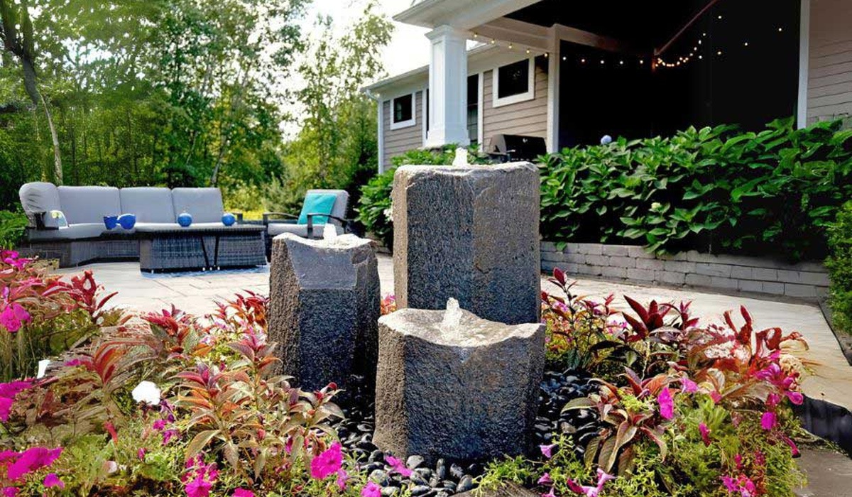 Basalt column fountain in backyard garden