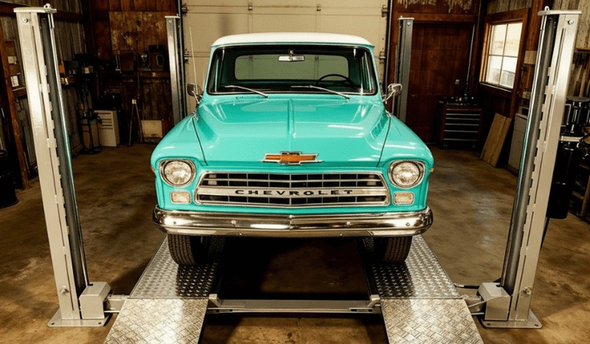 Turquoise vintage Chevrolet pickup on four-post car lift garage