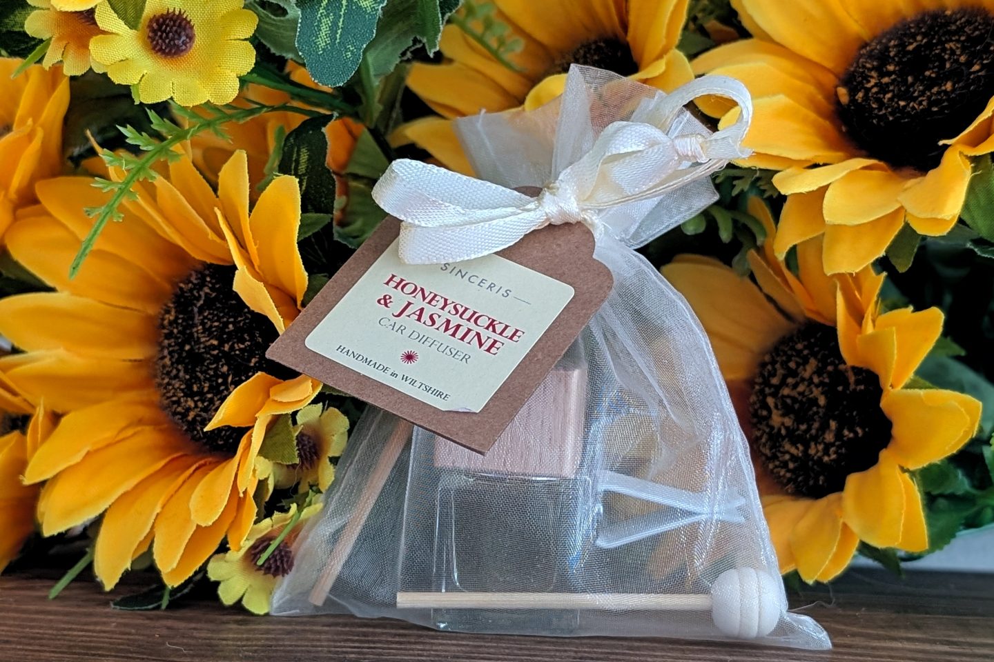SINCERIS handmade range - car diffuser displayed against sunflowers