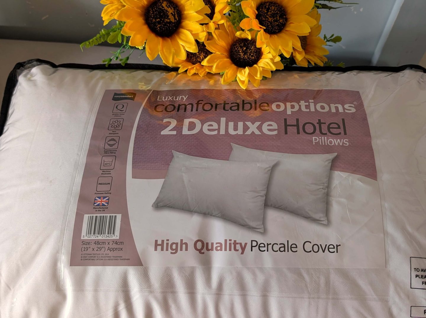 Pack of 2 Deluxe Pillows displayed with sunflowers