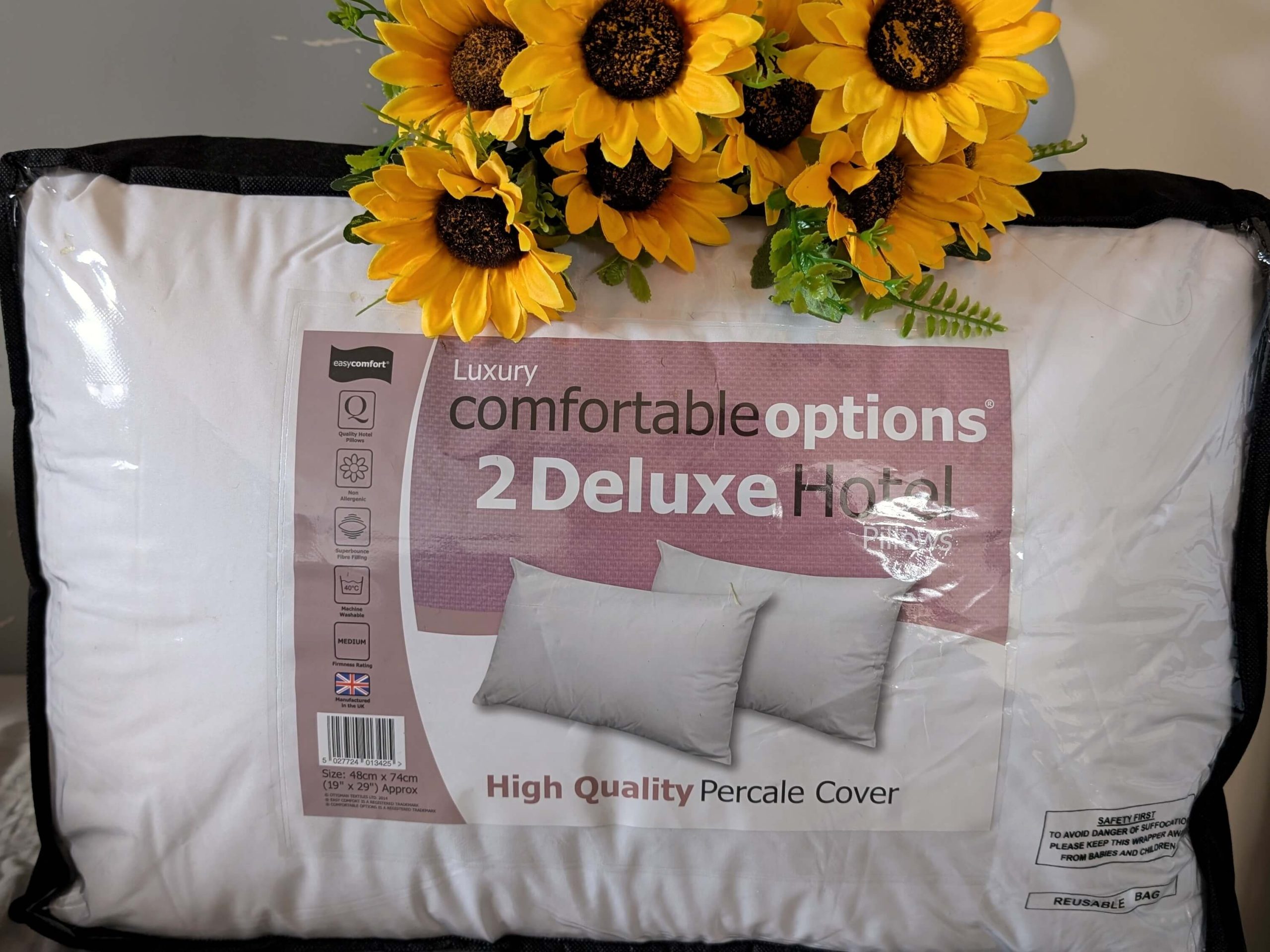 Pack of 2 Deluxe Pillows displayed with sunflowers
